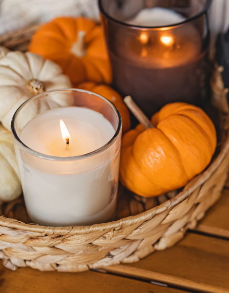 Image. Scented candles with small pumpkins in a basket.