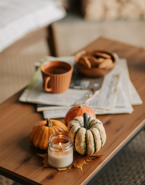 Image. Miniature pumpkins and coffee, on the wooden coffee table.